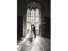 Bride and groom kiss in Athelhampton House weddign venue window